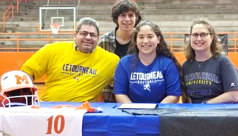 Izzy Tresca is seated between her mother and father, Sarah and Mike Tresca, and joined by her brother Anthony, as she accepts an offer to play softball for Letourneau University.